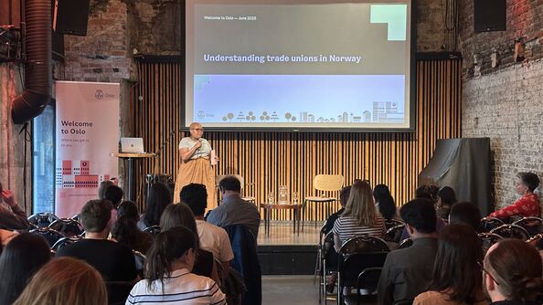 Woman on stage in front of a crowd