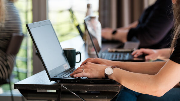 People taking notes on laptop
