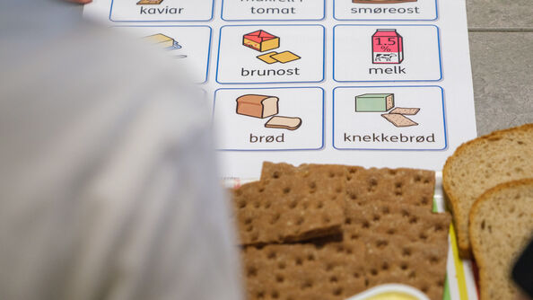 Child pointing at food on paper